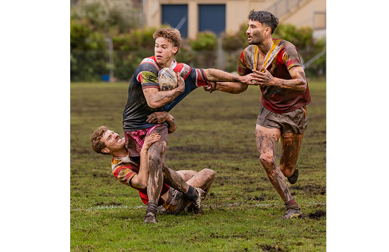 Coffs Comets players Jett McCarthy and Waka Petera shut down a charging Toby Batten.