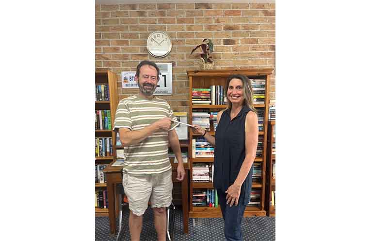 Bowraville photographer Rhys Grainger collected his prize money from photo competition organiser Ned Cowie.