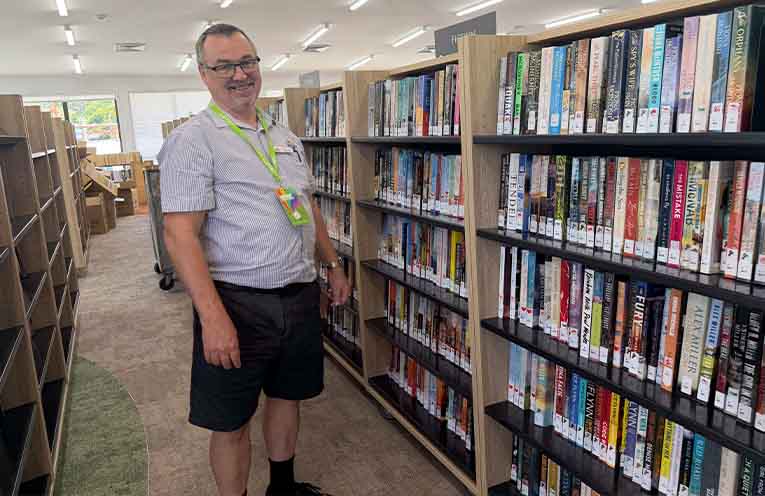 Nambucca Valley Library Officer Technical Services Mark Northover re-stocking the Macksville Library’s new shelves. Photo: supplied.