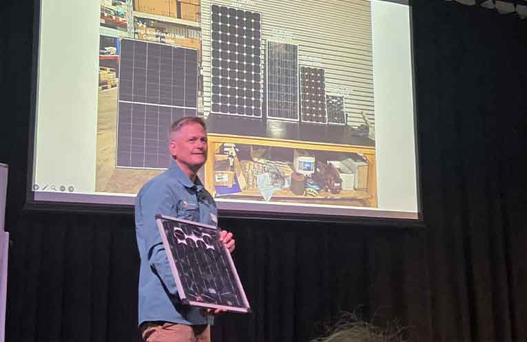Workshop presenter Geoff Tosio shows off his 1976 11-watt solar panel. Photo: Jessica Miller.