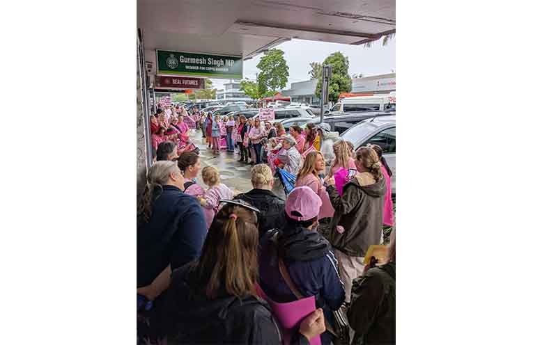 The rally gathers outside Gurmesh Singh’s office in Coffs Harbour. Photo: Lani Greenhalgh.