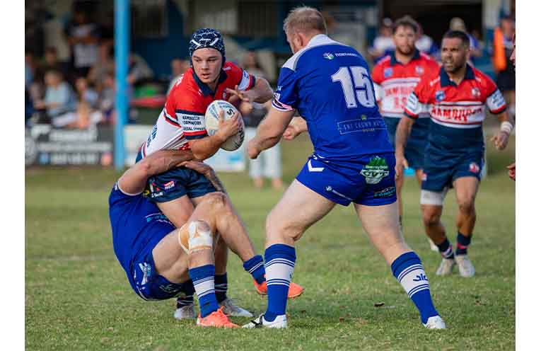 Roosters first grade’s Cale Ogilvy is wrapped up by Grafton defenders.