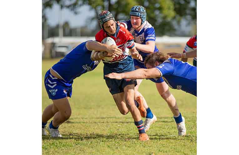 Roosters reserve grade player Antwone Robertson takes on the Grafton defensive line.