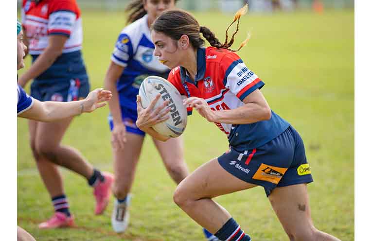Roosters women’s tackle player Teagan Craig on the attack.