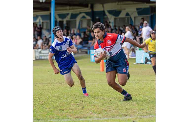 Roosters U18s player Kenny Walker heads for the tryline.