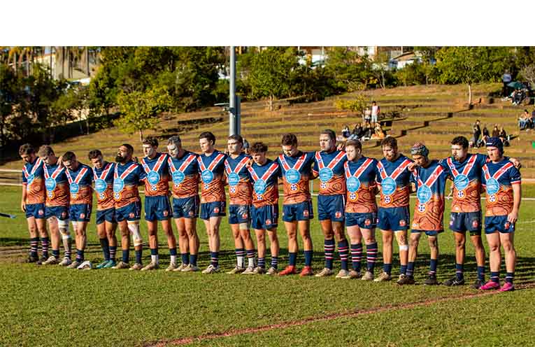 Nambucca Roosters first-grade players line up in their Indigenous Round jerseys, featuring the artwork of Gumbaynggirr artist Tehnaya West.