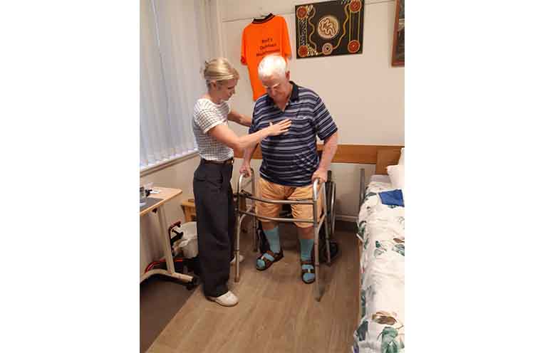 Physiotherapist Aimee Redman helping Jeff Bailey walk after two years. Photo: Val Bailey.