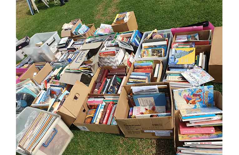Books among household goods and clothes at the free stall. Photo: Sharon Jane.