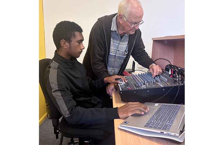 Garry Sambrook training Scott Cakakaka in the sound and media system.